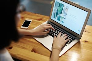 A person using a laptop computer.